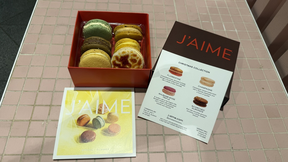Close up of crème brûlée macaron from J'aime les Macarons Auckland, Inside the box of six. - An Avid Traveller