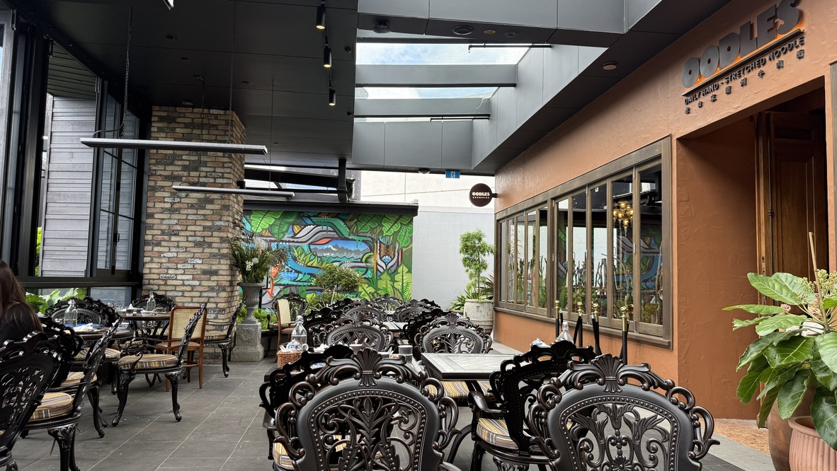 Outside view of Oodles Uyghur Chinese Halal Restaurant at Westfield Newmarket showing entrance and signage on a public holiday from the side