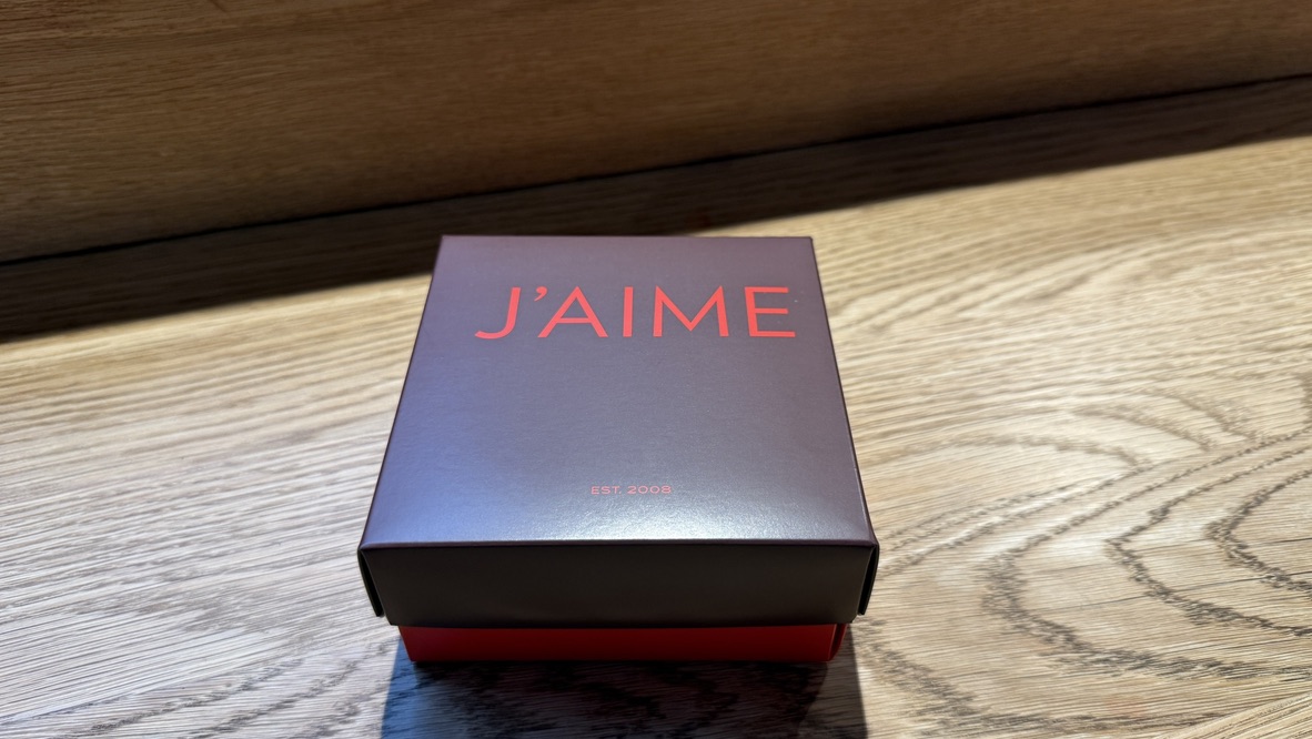 Close up of crème brûlée macaron from J'aime les Macarons Auckland, featuring a crisp shell and rich custard centre. - An Avid Traveller