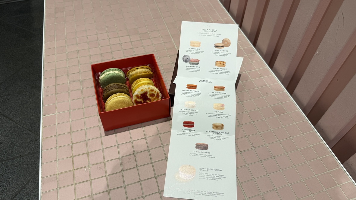 Close up of crème brûlée macaron from J'aime les Macarons Auckland, Inside the box of assorted six. - An Avid Traveller